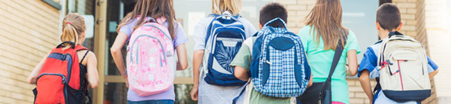 Kids walking to school with backpacks on their back