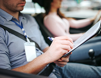 Driving instructor in car with student